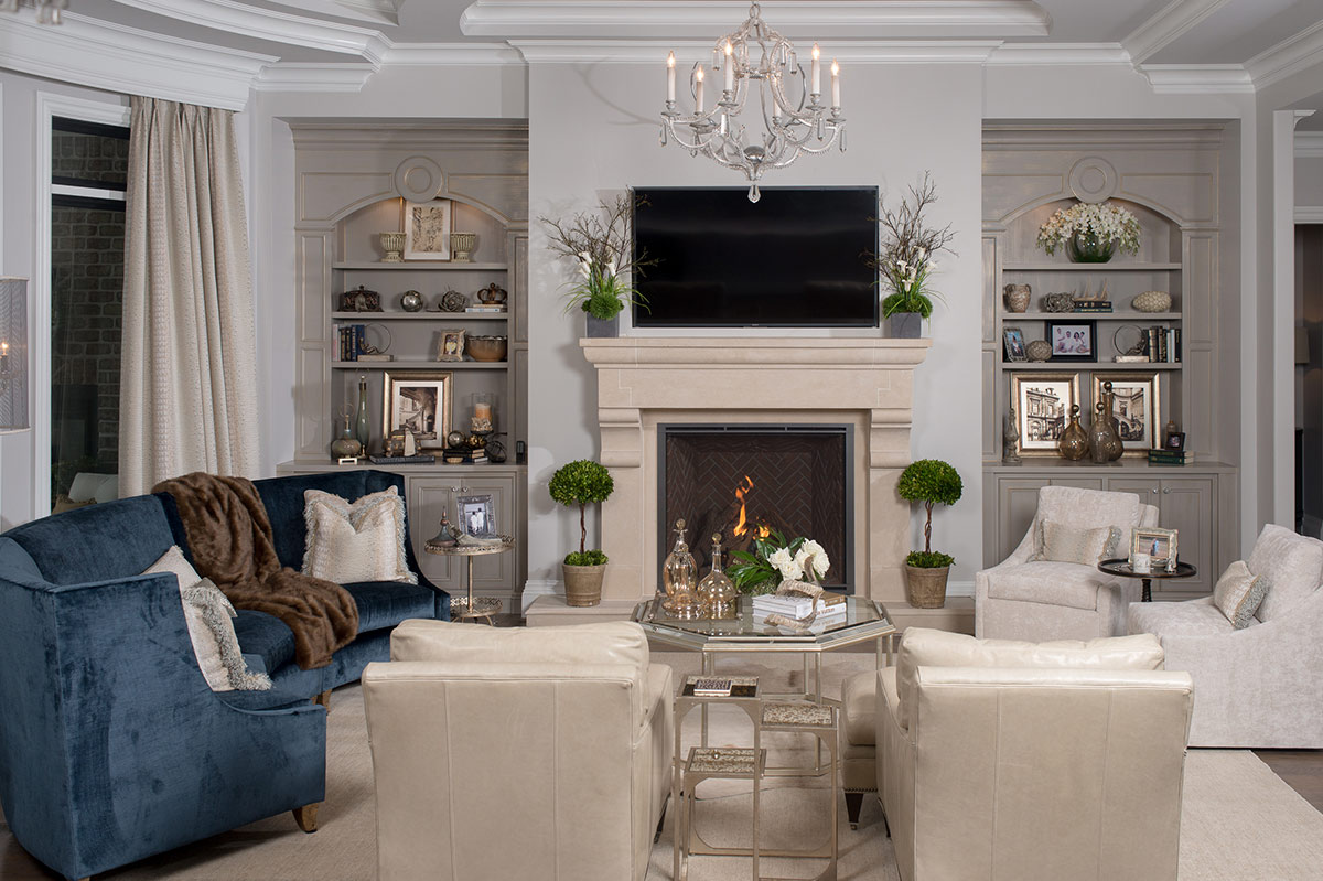 Great room with custom built-in cabinetry and a fireplace surround
