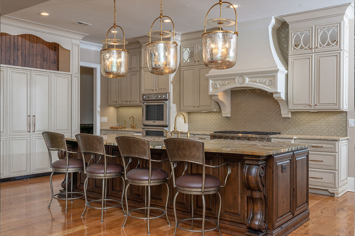 Custom kitchen with a large island, pendant lighting and full height cabinetry