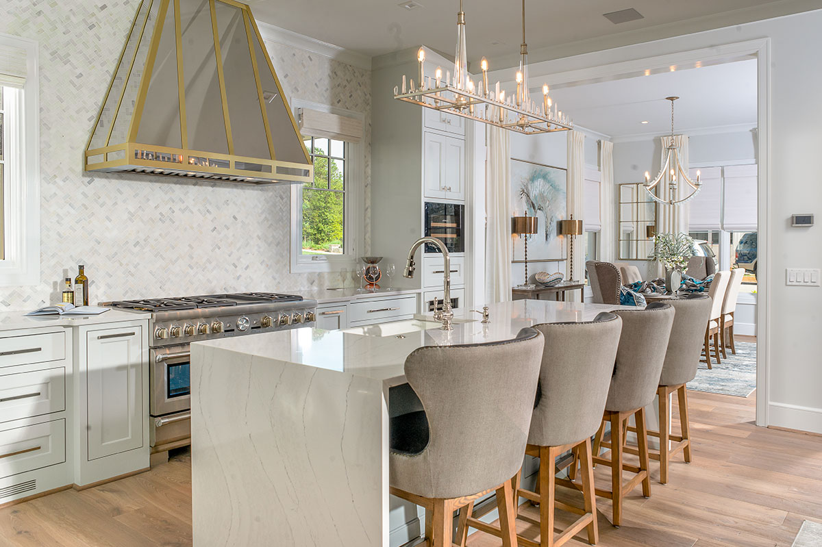 Custom kitchen with a wood range hood and seated island