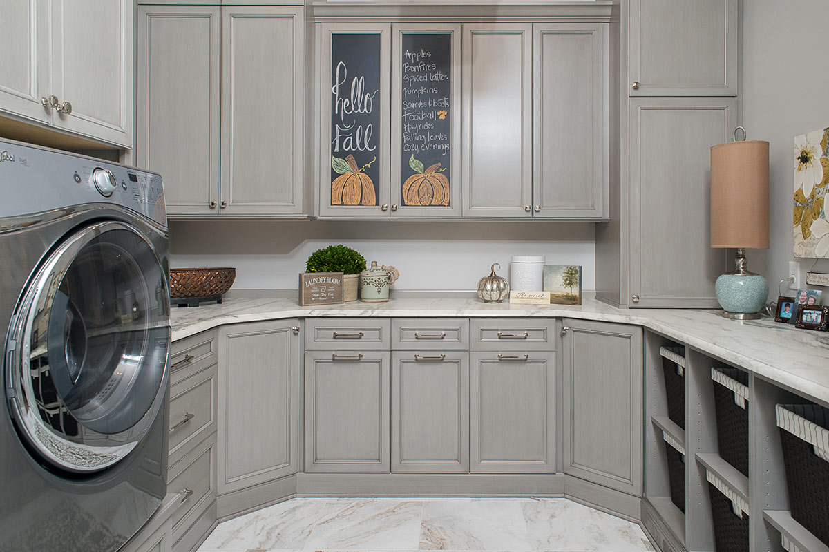 Custom laundry room cabinetry with counter space and storage