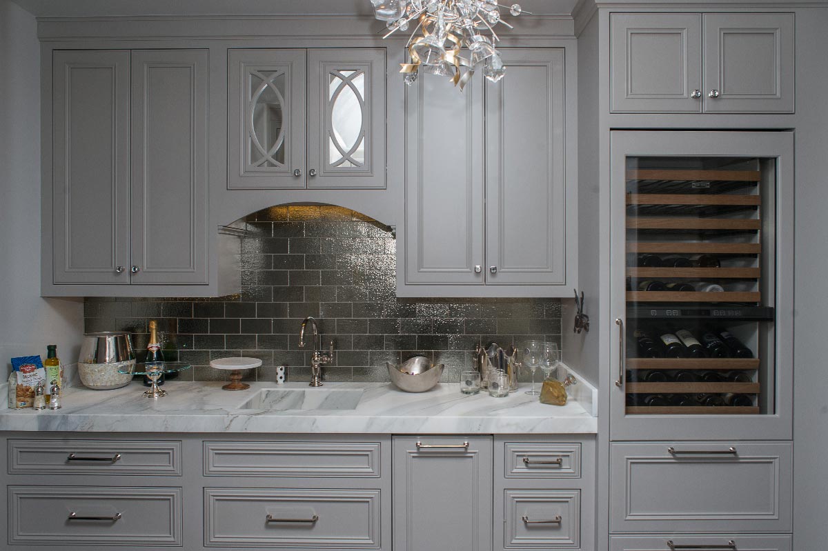 Custom pantry cabinetry with glass fronted upper doors