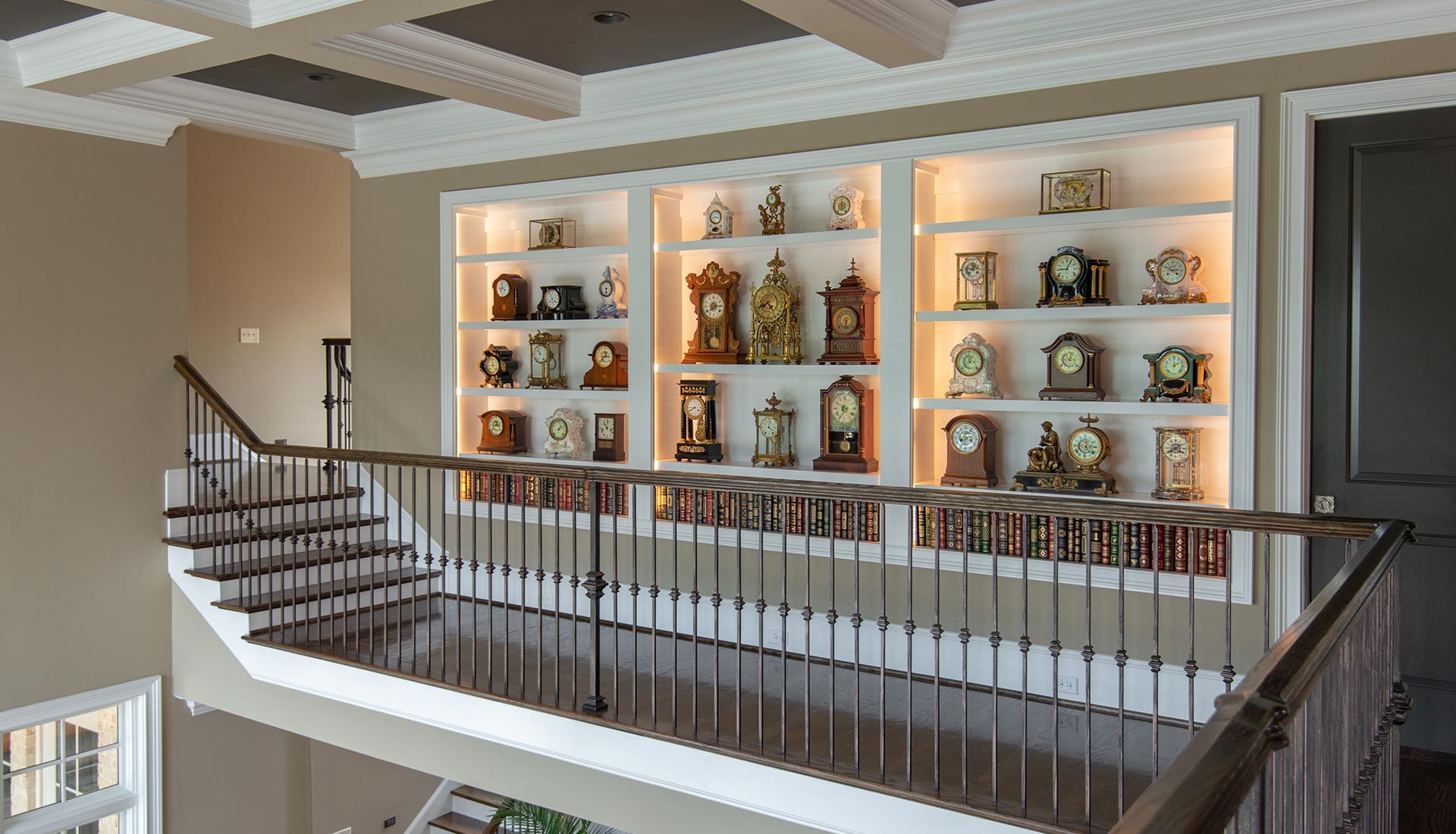 Two story custom library and wine display with iron railing
